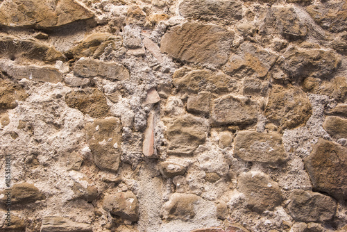 Stone wall background and ancient tuff  Tuscany in Italy