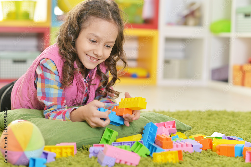 girl playing with colorful plastic blocks girl playing with colorful plastic blocks