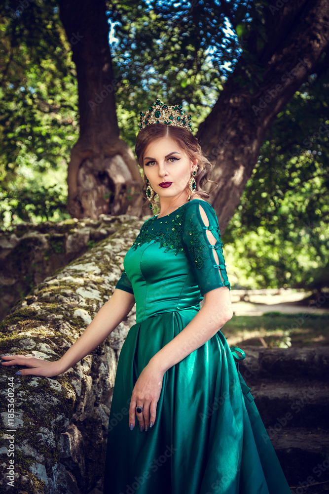Young woman wearing a green dress explores a magical forest Young woman wearing a green dress explores a magical forest
