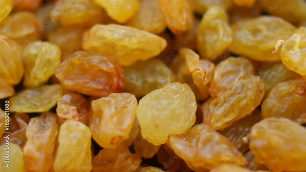 Raisins close up. Loop rotation. Front of the camera rotates plate with raisins Raisins close up. Loop rotation. Front of the camera rotates plate with raisins