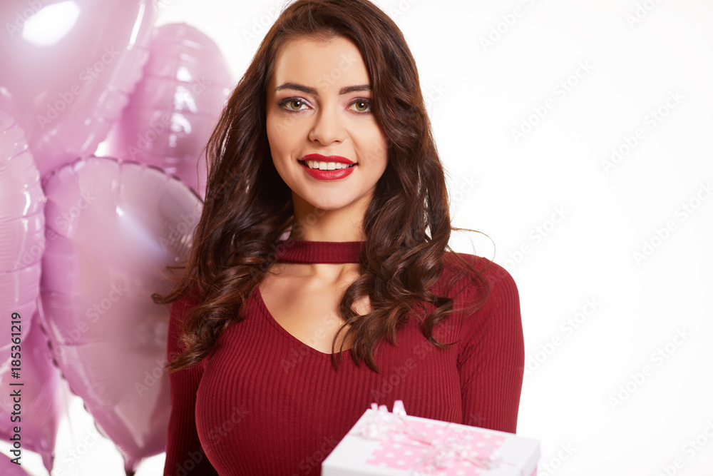 Beautiful fashion woman in red posing with pink ballons Beautiful fashion woman in red posing with pink ballons