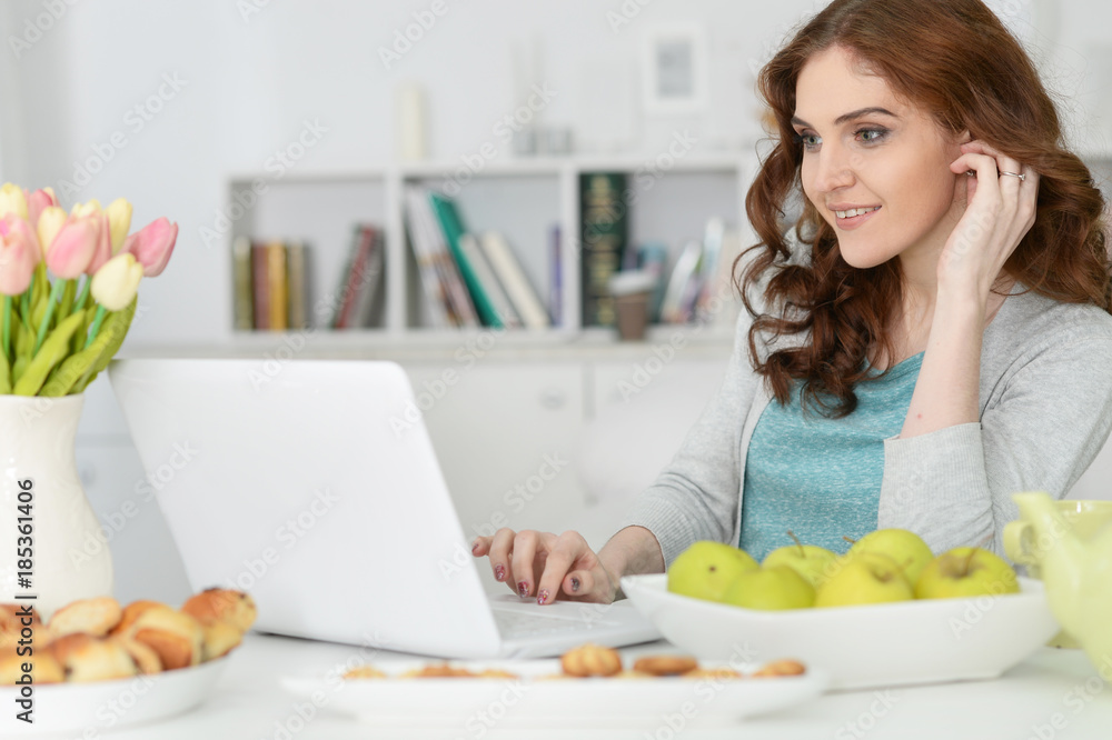  woman  using  laptop  at table