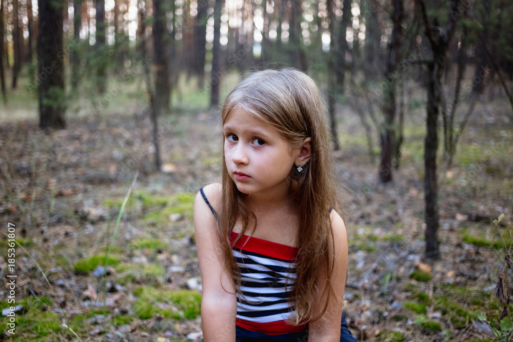 Beautiful little girl in the pine forest in summer. Beautiful little girl in the pine forest in summer.