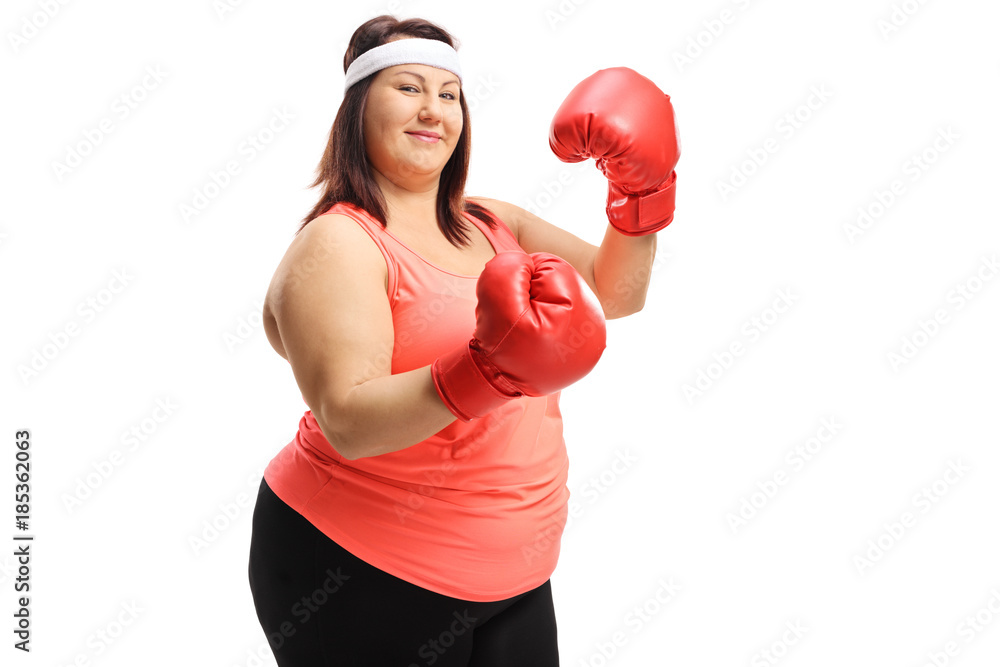Overweight woman posing with a pair of red boxing gloves Overweight woman posing with a pair of red boxing gloves