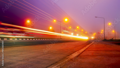 highway bridge at night with traces of light traffic