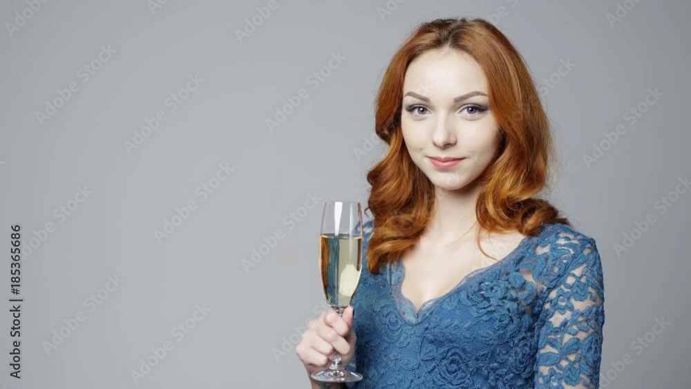 Portrait of redheaded female in lace dress with glass of champagne Portrait of redheaded female in lace dress with glass of champagne