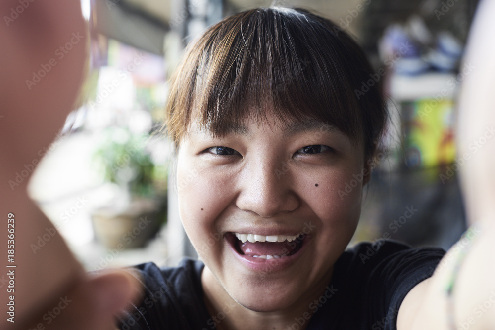 Portrait of laughing woman taking selfie with smartphone Portrait of laughing woman taking selfie with smartphone