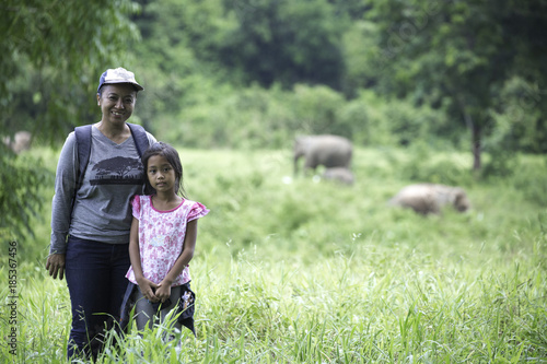 mom and dughter enjoy to see wild elephant in the forest © nakhonthesis