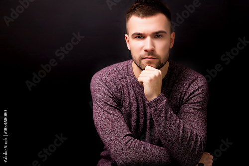 Handsome serious man isolated on a black background