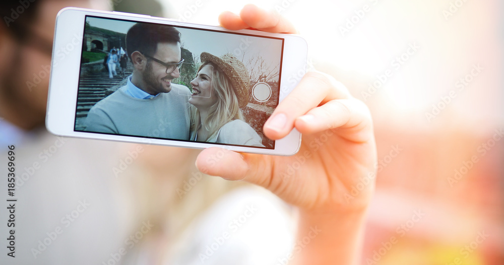 Happy couple having fun and taking a selfie