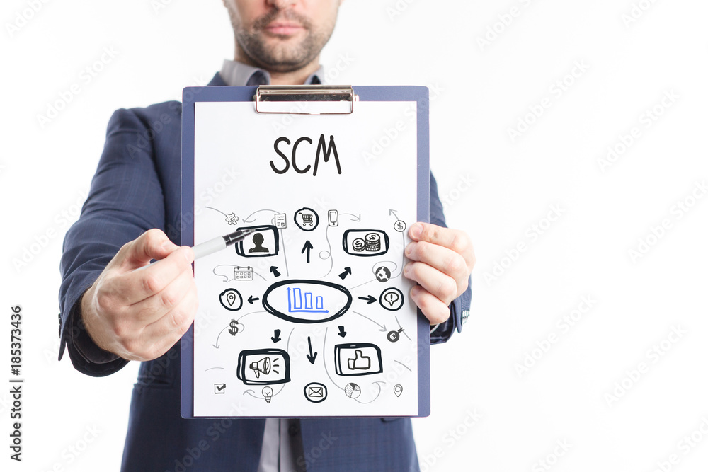 The concept of business, technology, the Internet and the network. A young businessman shows a successful scheme of work: SCM The concept of business, technology, the Internet and the network. A young businessman shows a successful scheme of work: SCM