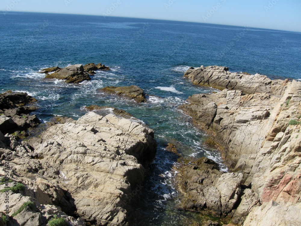 Rocky coast enters the sea and merges into a beautiful whole