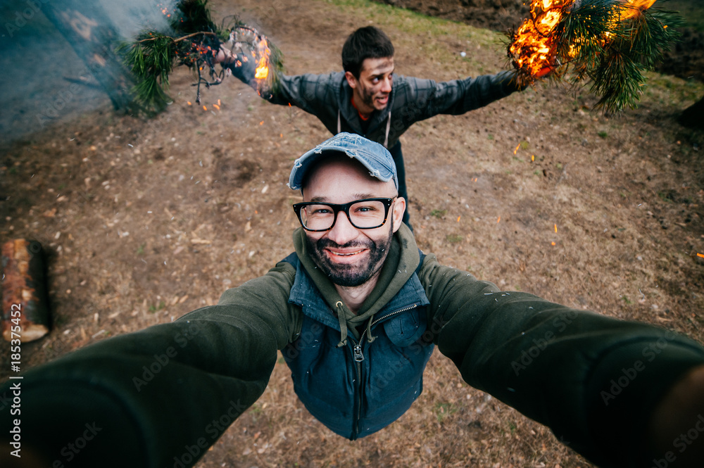 Frineds make selfie. Crazy funny boys mess around. Men at nature ...