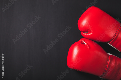 Professional red boxing gloves on black background with copy space. © happy_author
