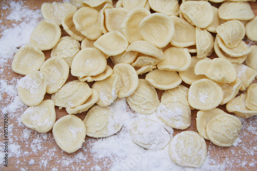 Fresh orecchiette. Italian traditional pasta on wooden table with flour