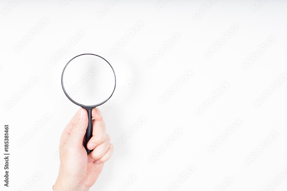 A man hand holding magnifying Glass on white background. A man hand holding magnifying Glass on white background.