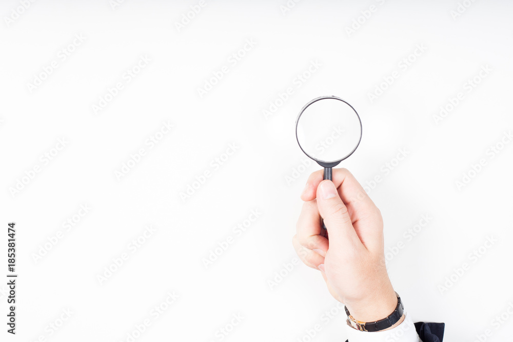 A man hand holding magnifying Glass on white background. A man hand holding magnifying Glass on white background.