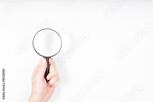 A man hand holding magnifying Glass on white background.