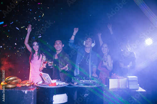 Night club and DJ party with friendsin new year party, dancing and celebrating concept