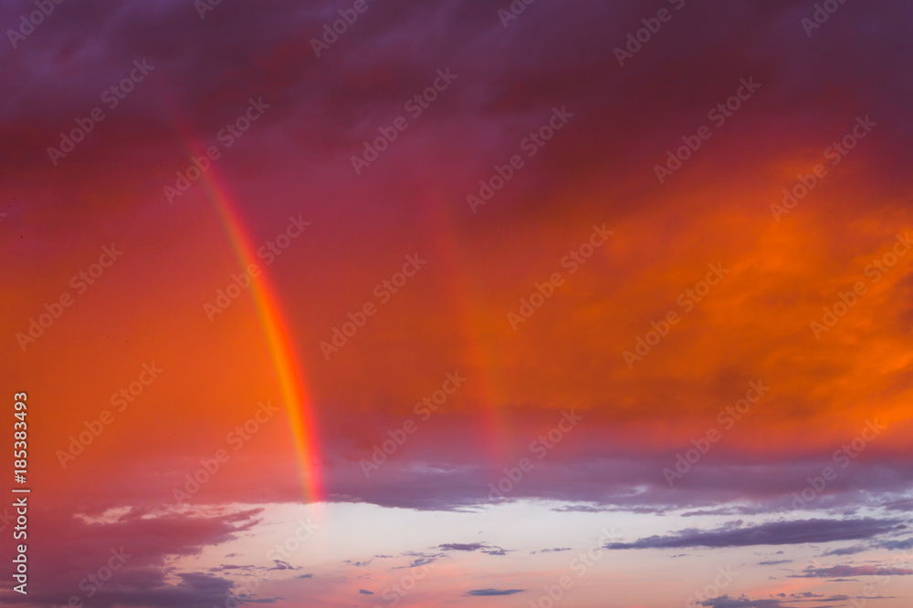 Double rainbow in the purple evening sky