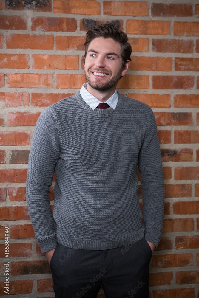 Smiling executive standing with hands in pocket Smiling executive standing with hands in pocket