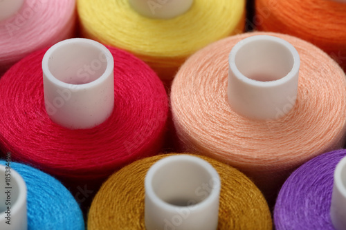 A colorful spool with threads often used in tailoring and is an indispensable element of this profession. 