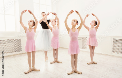 Teacher helping her students during dance class photo