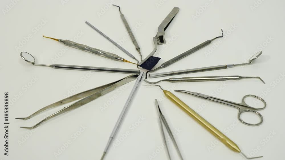 Hands in the gloves taking from the table a dental tools Hands in the gloves taking from the table a dental tools