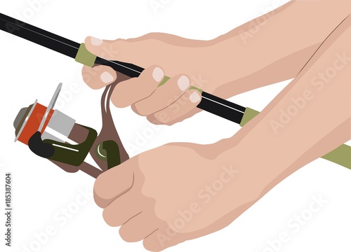 isolated fishing reel and hands of angler
