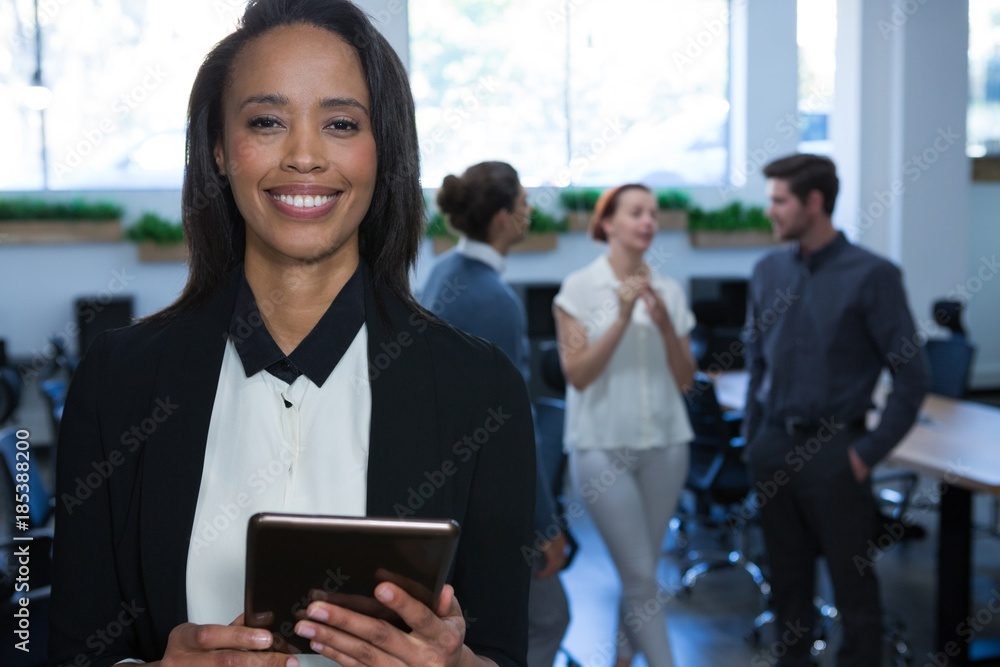 Female executive using digital tablet in office Female executive using digital tablet in office