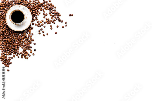 Cup of freshly brewed full-bodied coffee on white table top view copyspace. Coffee background.