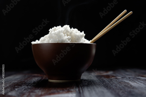 hot rice in brown bowl with chopsticks in japanese style