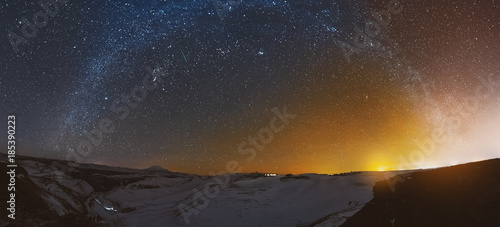 Bilde på lerret Night panorama of the sunset with the milky way in the Caucasus in winter