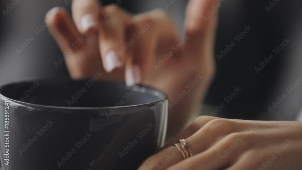 Woman holding cup in hands and drinking tea, close up Woman holding cup in hands and drinking tea, close up