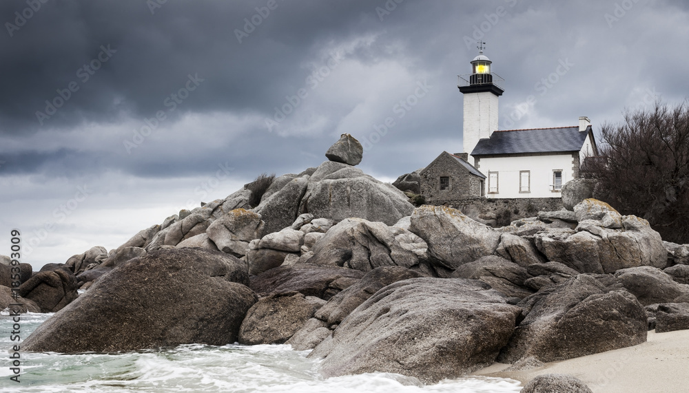 Coastline landscape in low tide with lighthouse and peculiar rocks in Brittany, France Coastline landscape in low tide with lighthouse and peculiar rocks in Brittany, France