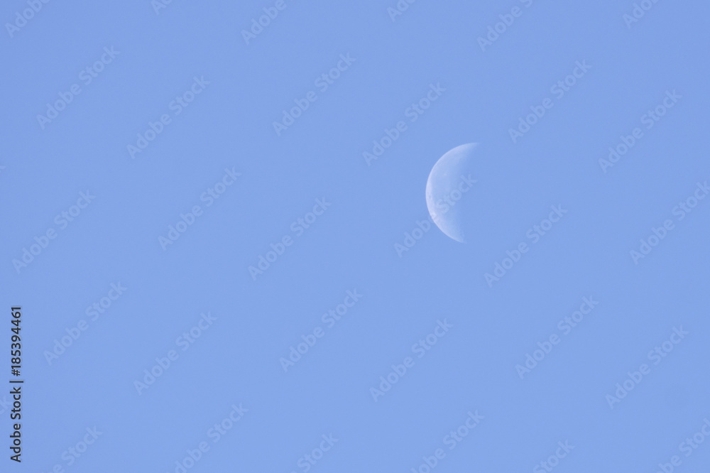 moon in a clear sky under a bright sun moon in a clear sky under a bright sun