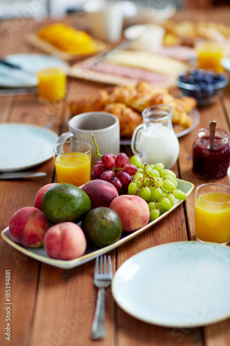 fruits, juice and other food on table at breakfast