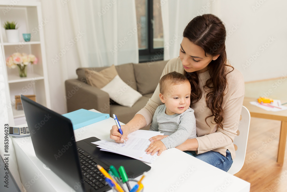 happy mother with baby and papers working at home happy mother with baby and papers working at home