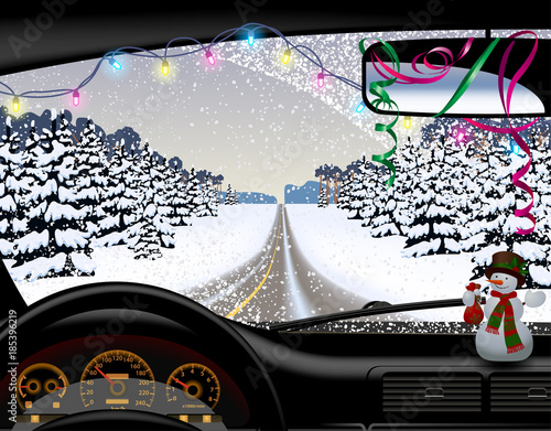 Winter road in snowfall from inside of the car