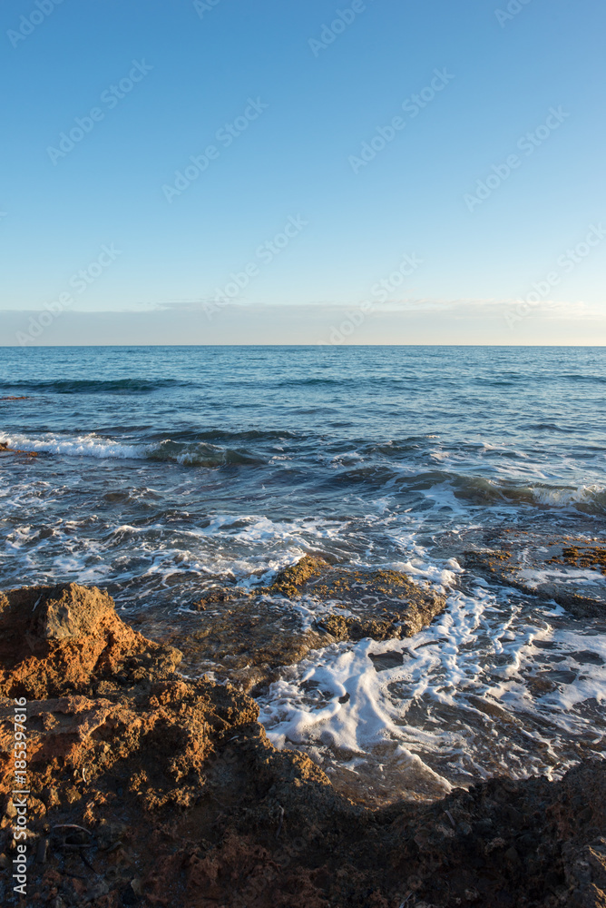 The calm sea in a very cloudy sunset