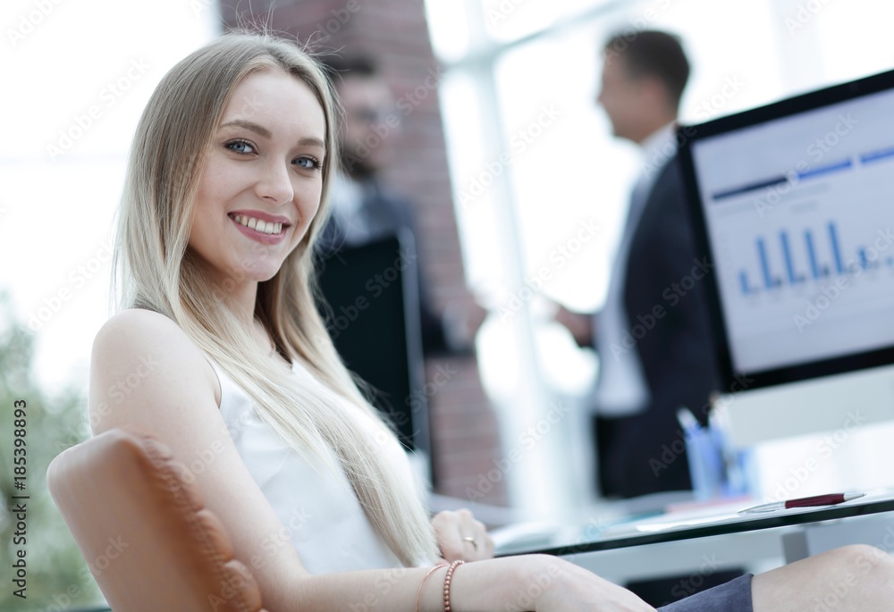 young business woman sitting at a desk in the office .