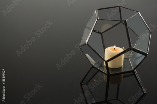 Lit candle on candle holder