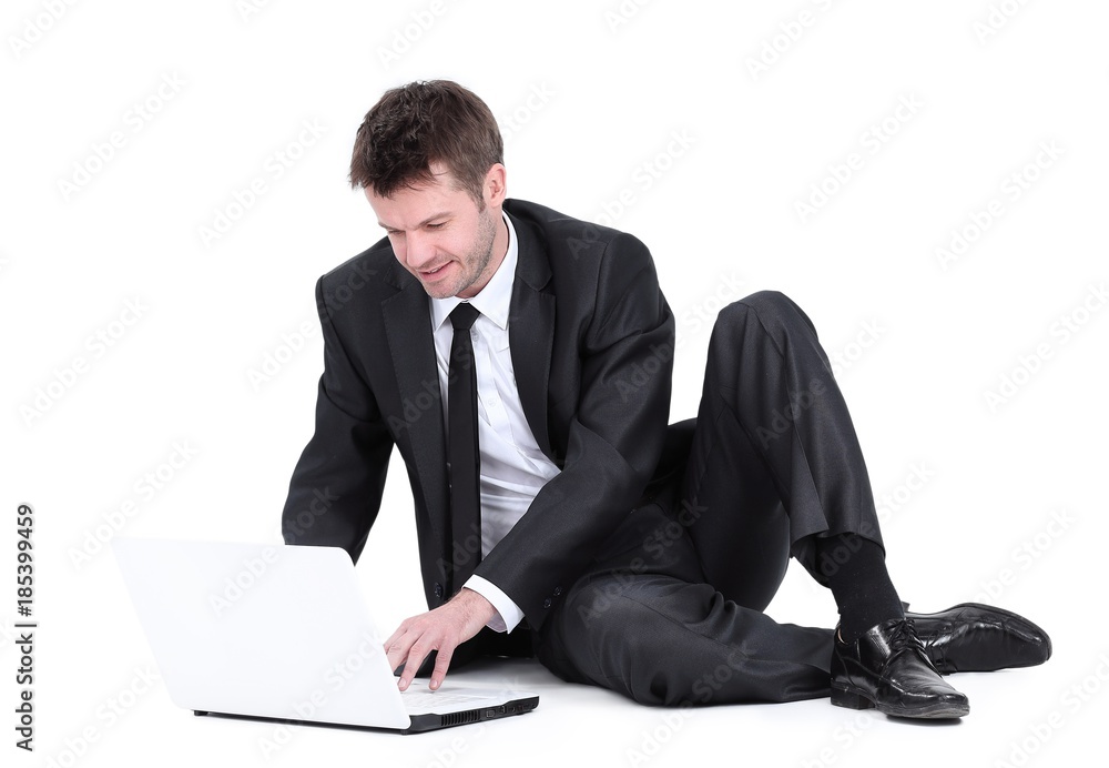 businessman with laptop sitting on the floor. businessman with laptop sitting on the floor.