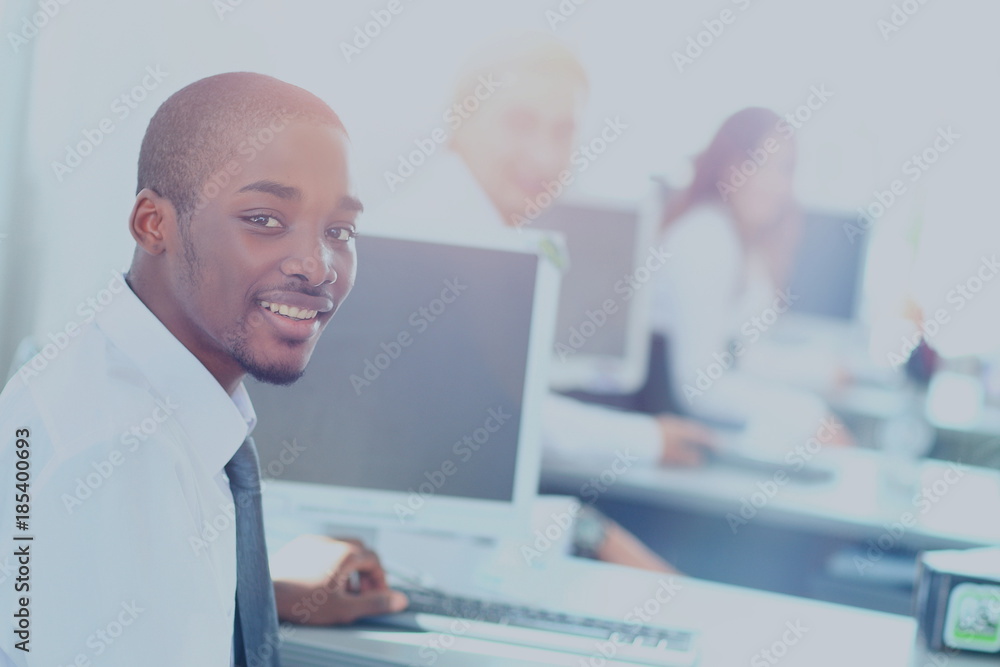 Portrait of a happy African American entrepreneur displaying computer laptop in office Portrait of a happy African American entrepreneur displaying computer laptop in office