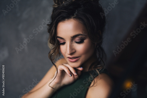 Portrait of aucasian woman with make up and curly hair in stylish scandinavian interiors, cozy atmosphere, pretty and beautiful close up portrait