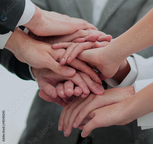 Fototapeta Naklejka Na Ścianę i Meble -  Close-up of business partners making pile of hands at meeting