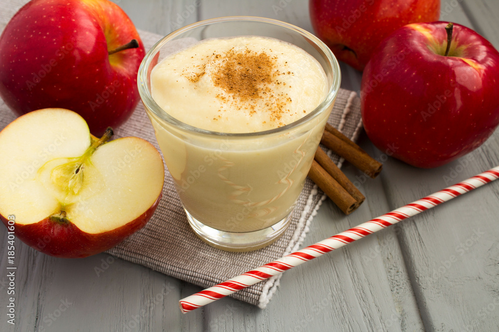 Smoothies from red apples and cinnamon on the grey napkin Smoothies from red apples and cinnamon on the grey napkin