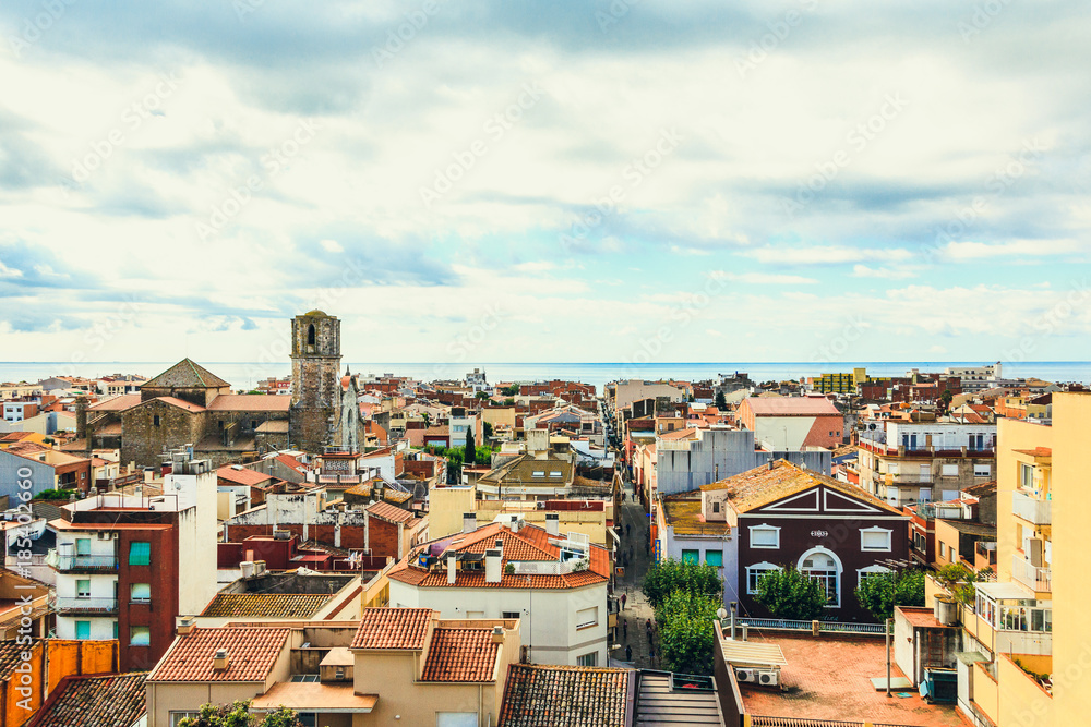 View of the old spanish town Malgrat de Mar, roof tops with red tile, cityscape on the coast of Mediterranean sea, Costa Brava, province of Barcelona, Catalonia, Spain. Travel and vacation. Top view.