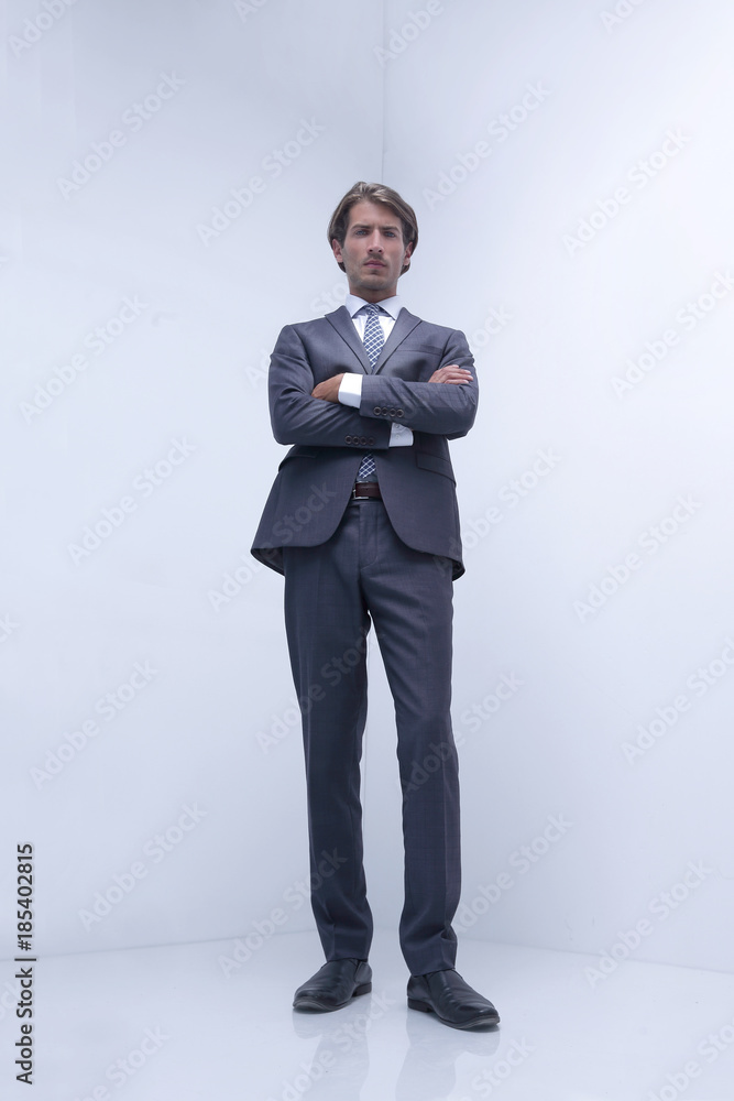 serious businessman standing in a blank room. serious businessman standing in a blank room.