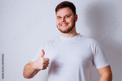 young cheerful man showing thumb up